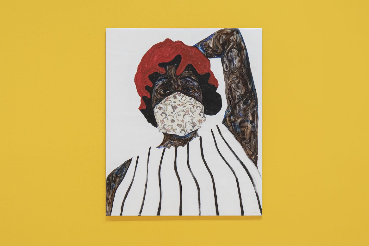 Photo of a canvas depicting a woman wearing a red hat and a face mask on a yellow wall.