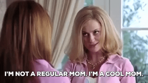 A woman in a pink tracksuit winking and saying "I'm not a regular mom. I'm a cool mom."