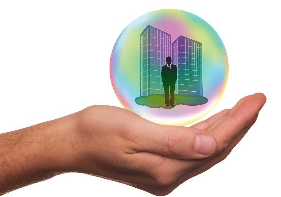 Safety of having the correct Crime Insurance for your business Hand holding globe with person and 2 buildings
