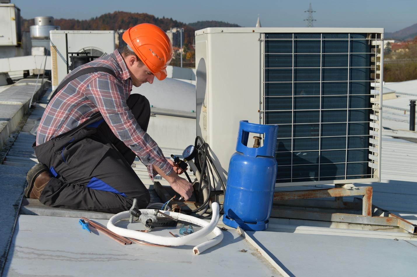 A person working on a roof

Description automatically generated