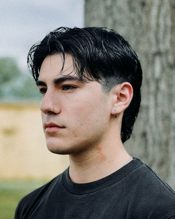 Full picture of a man wearing the flat lying mullet with a burst