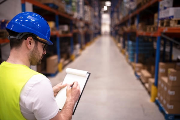 factory-worker-holding-clipboard-checking-inventory-warehouse-storage-department