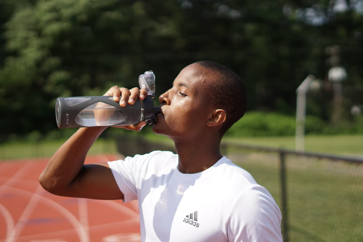 man drinking water after running. exercise