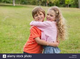 Two smiling kids hugging at park Stock Photo: 67473474 - Alamy