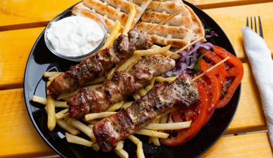 Plate of chips, skewers and bread