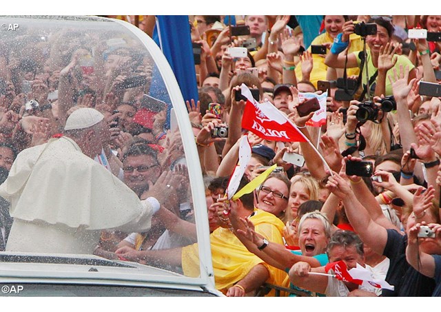 Pope Francis greets faithful and pilgrims on his way to the Royal Wawel Castle in Krakow - AP