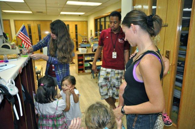 A parent drops off her children at the Child Development Center for the Community Parents' Night Out, Aug. 17. (U.S. Army photo by Cpl. Han Samuel)