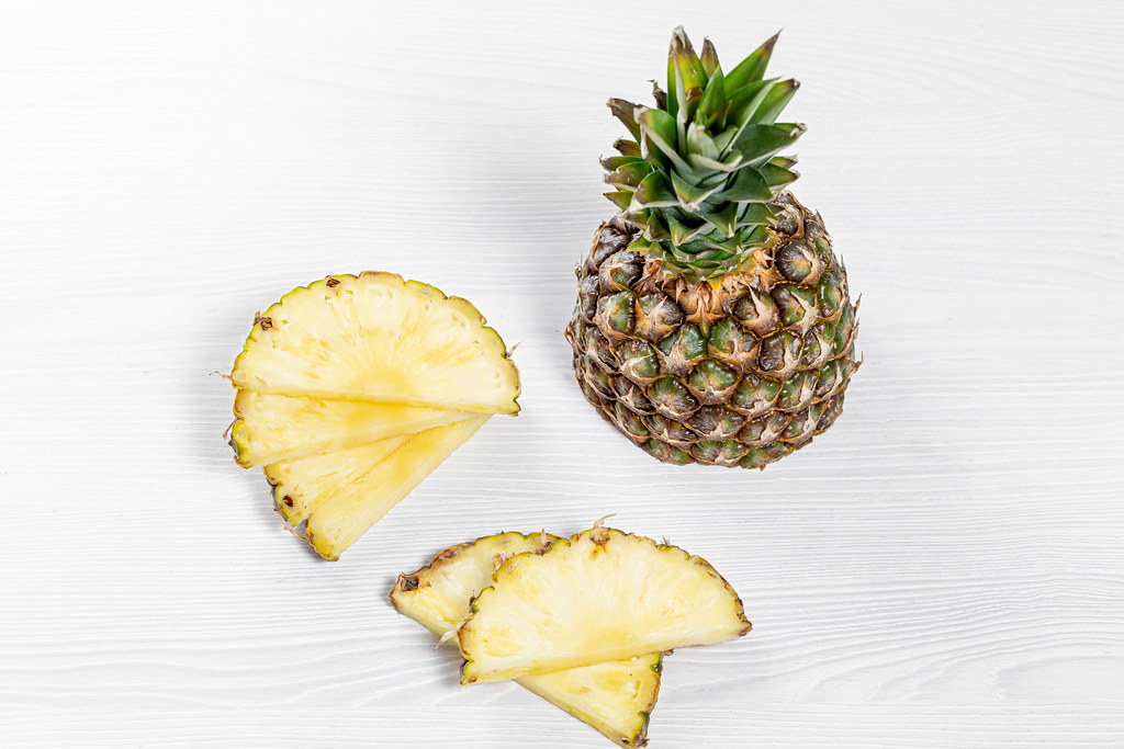 Half and pieces of fresh pineapple on white background | Flickr