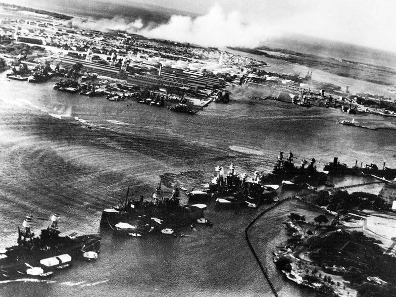aerial view of battleship row in the opening moments of the japanese attack on pearl harbor