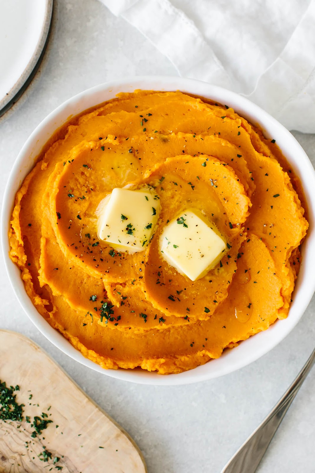 Mashed sweet potatoes topped with butter.