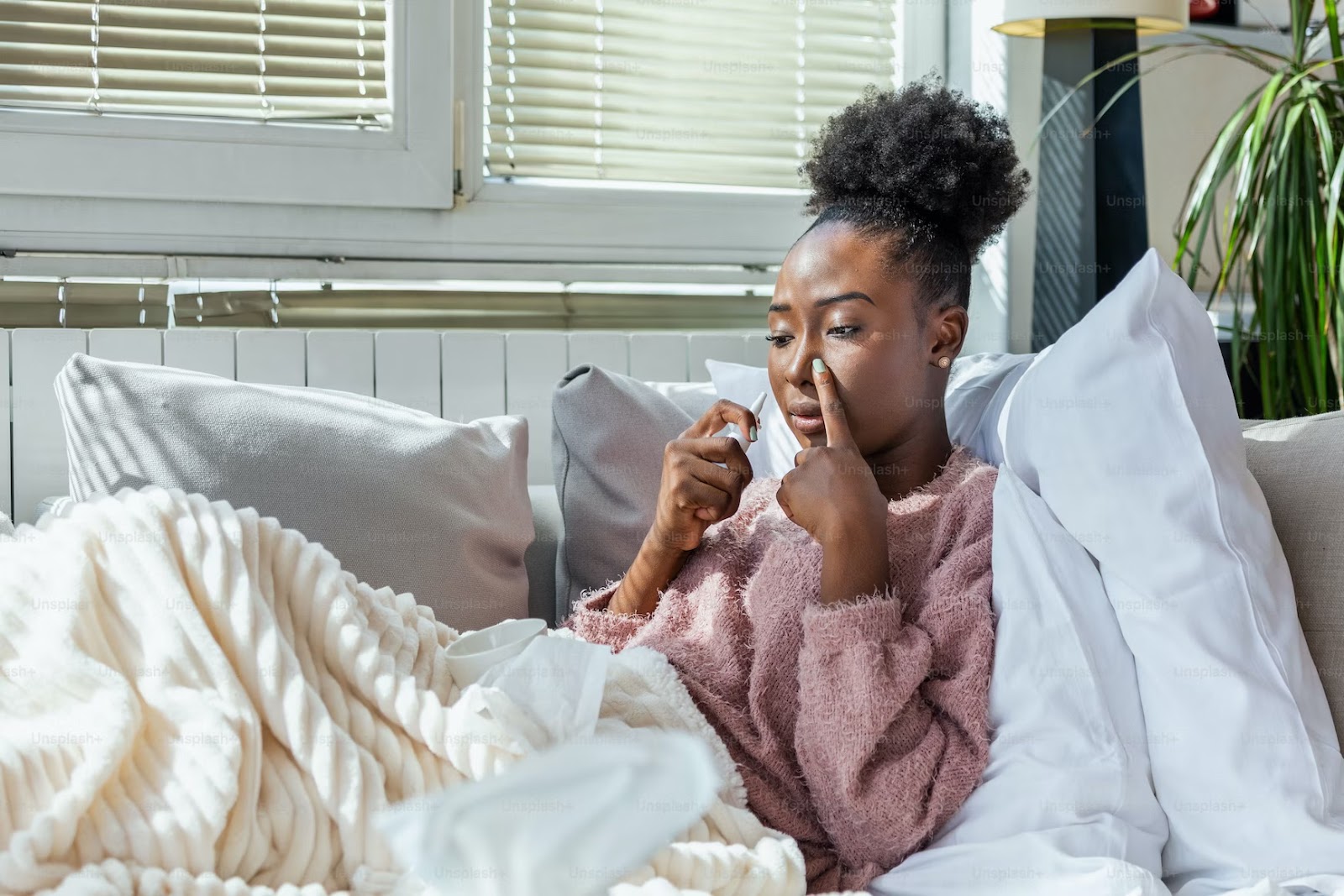 Girl using nasal spray - Autumn Allergies
