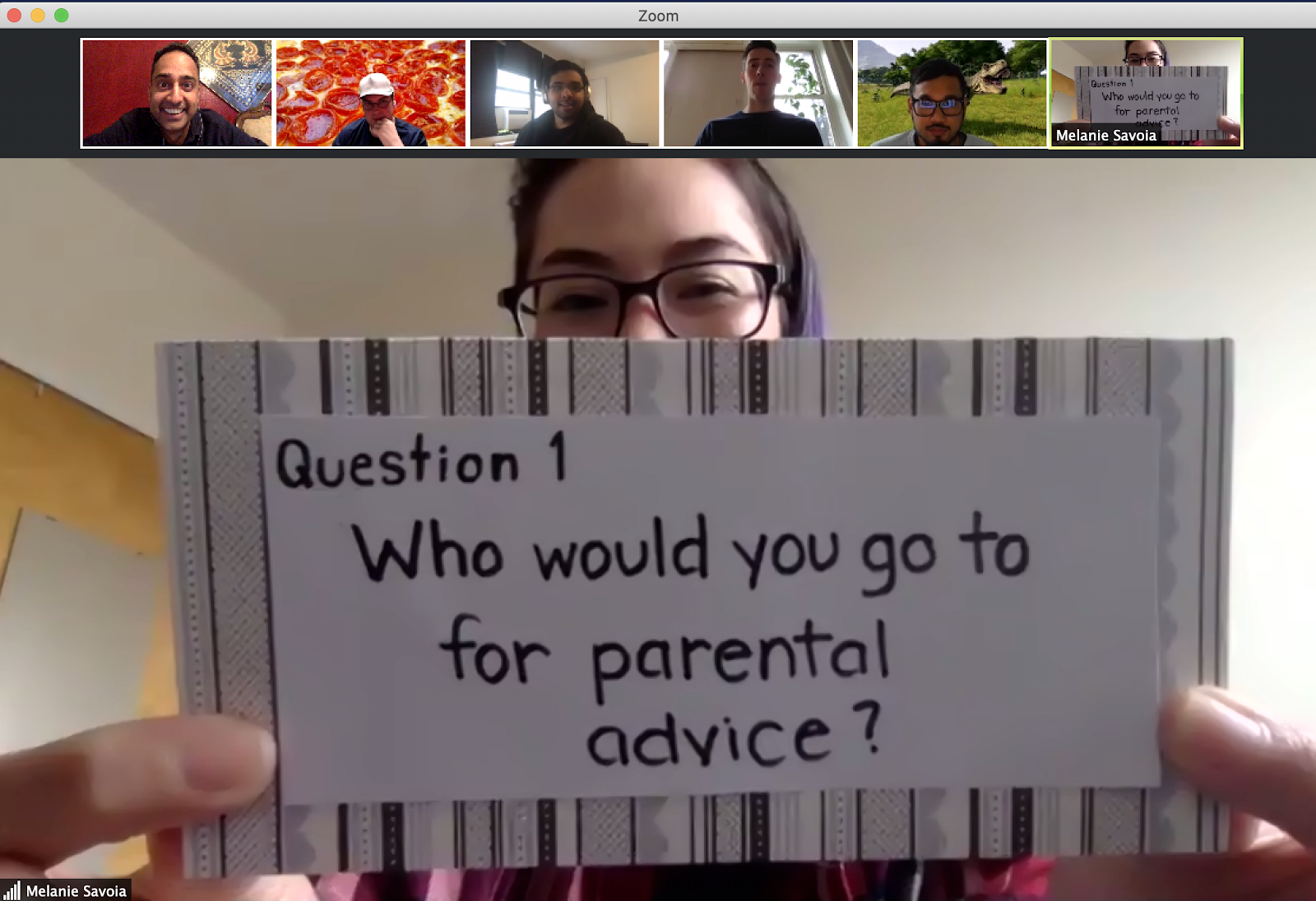 Zoom meeting with 6+ videos, one person displaying question for Family Feud game.