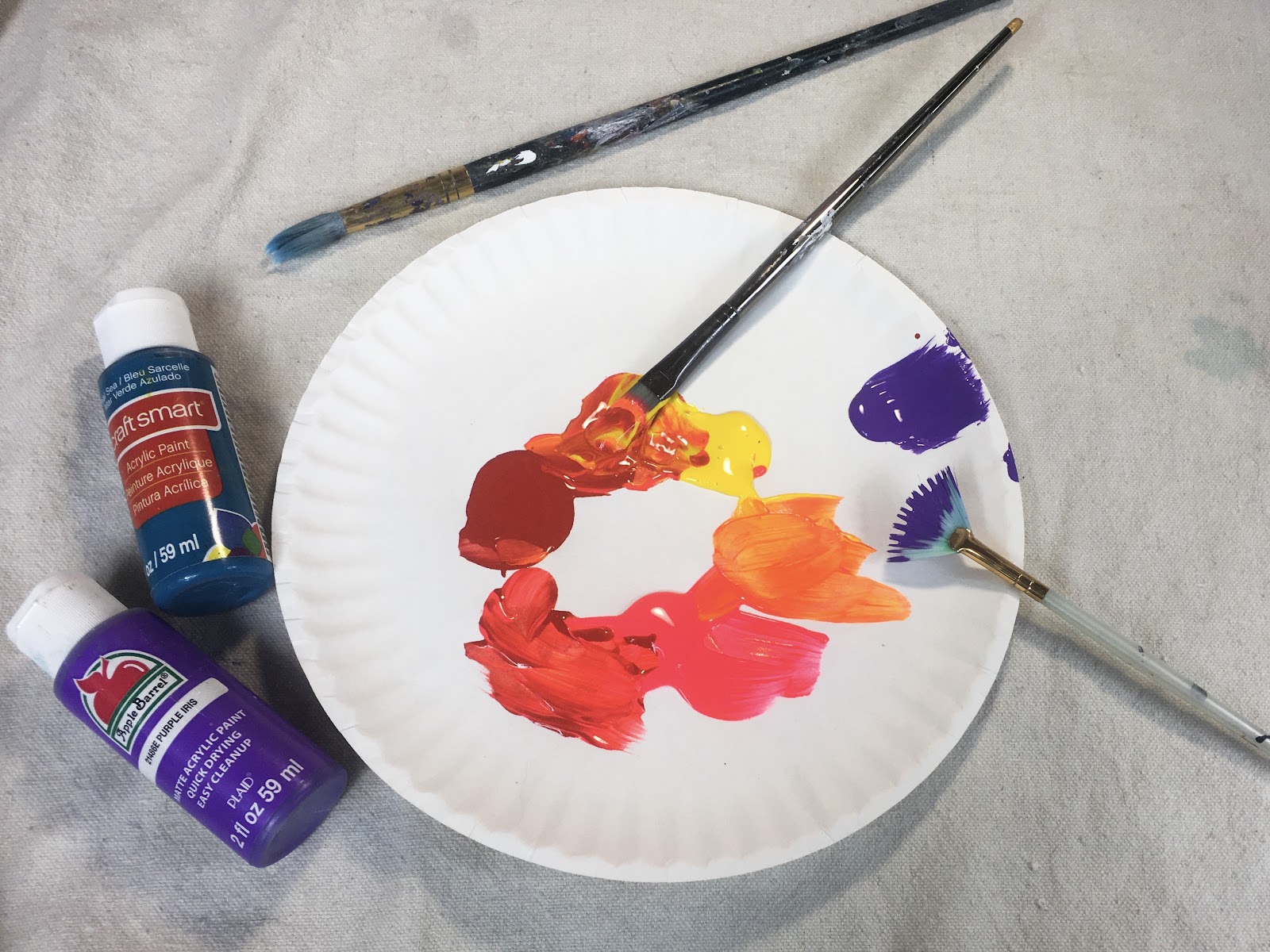 paint on a plate with paint brushes