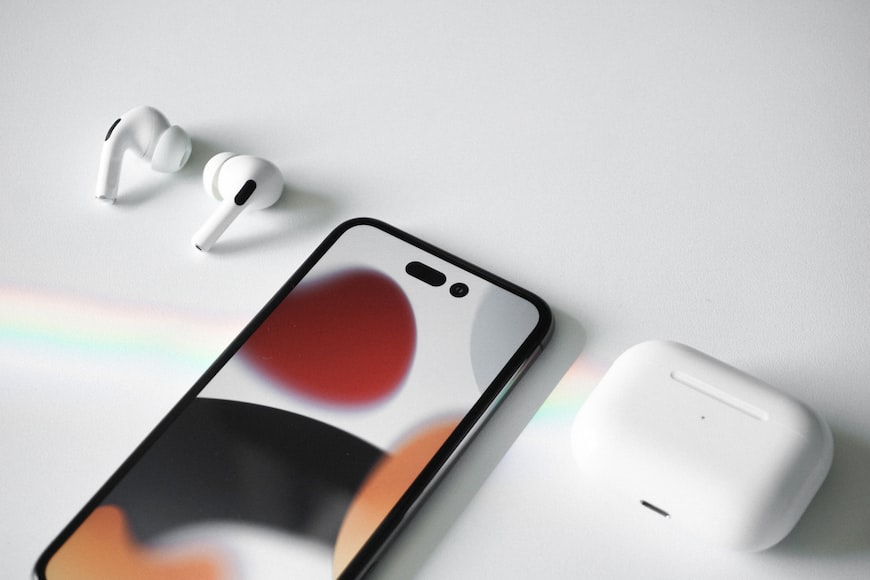 This image shows the iPhone 14 Pro with AirPods.