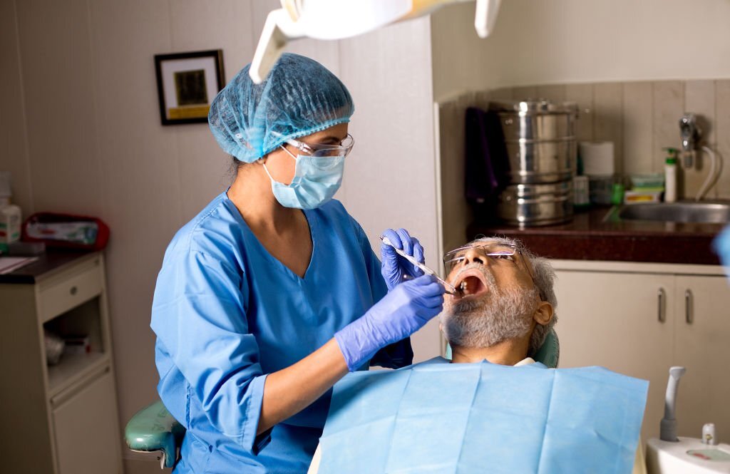 a dentist providing oral service to the senior citizen 