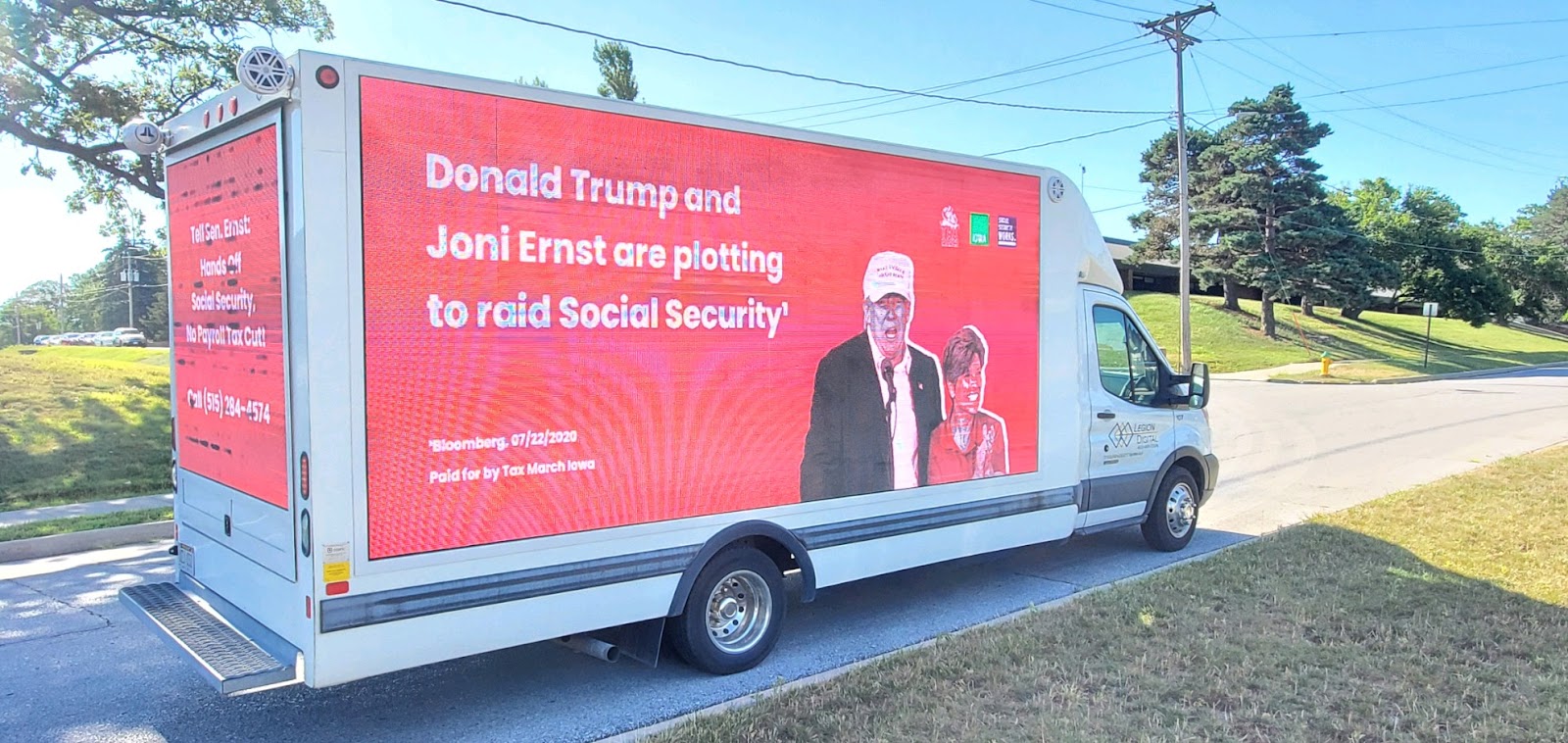 Billboard in Iowa reading: Donald Trump and Joni Ernst are plotting to raid Social Security
