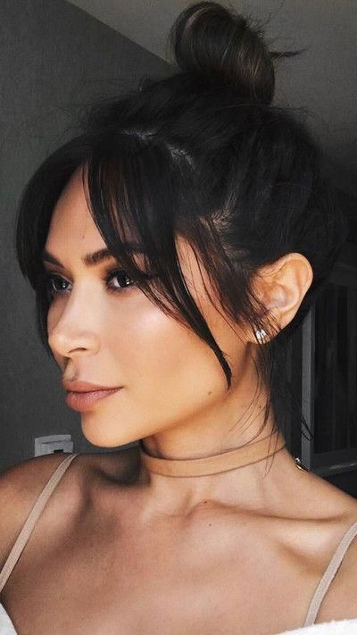 lady wearing her hair in a ponytail with long bangs