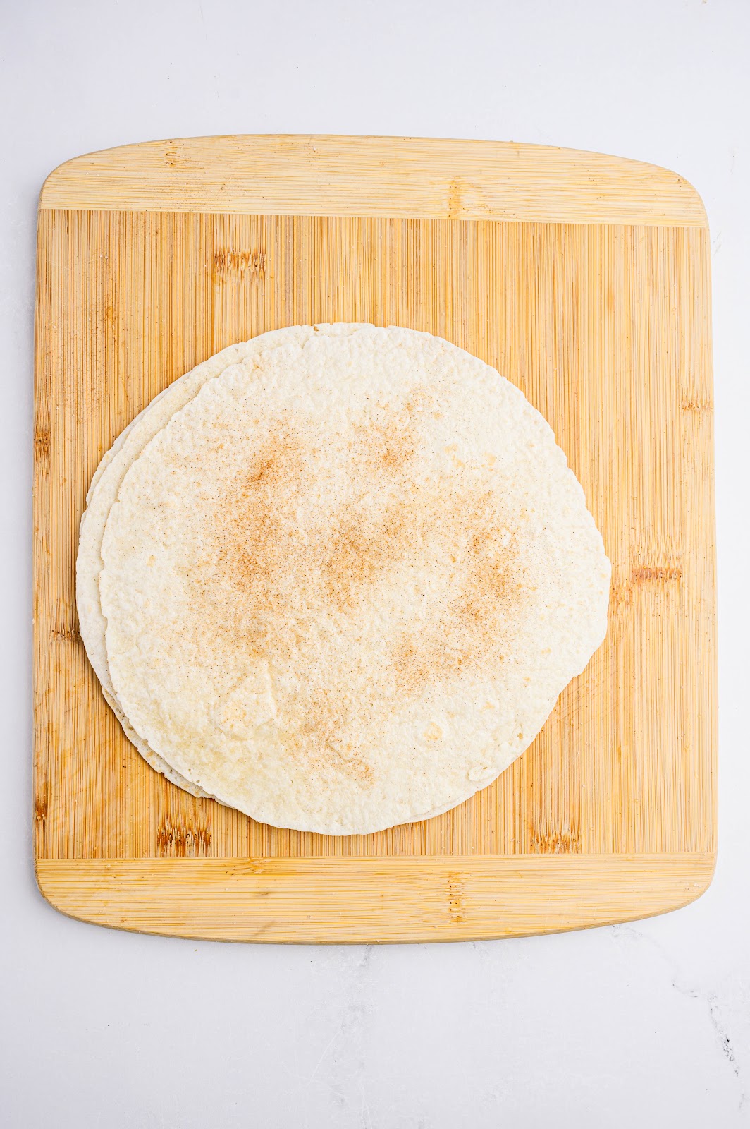 Brush your tortillas with water. Sprinkle the cinnamon sugar evenly over both sides of your tortillas.
