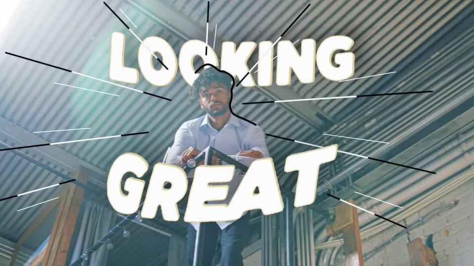 screenshot from a video displaying the text "looking great" over an image of a man in a dress shirt