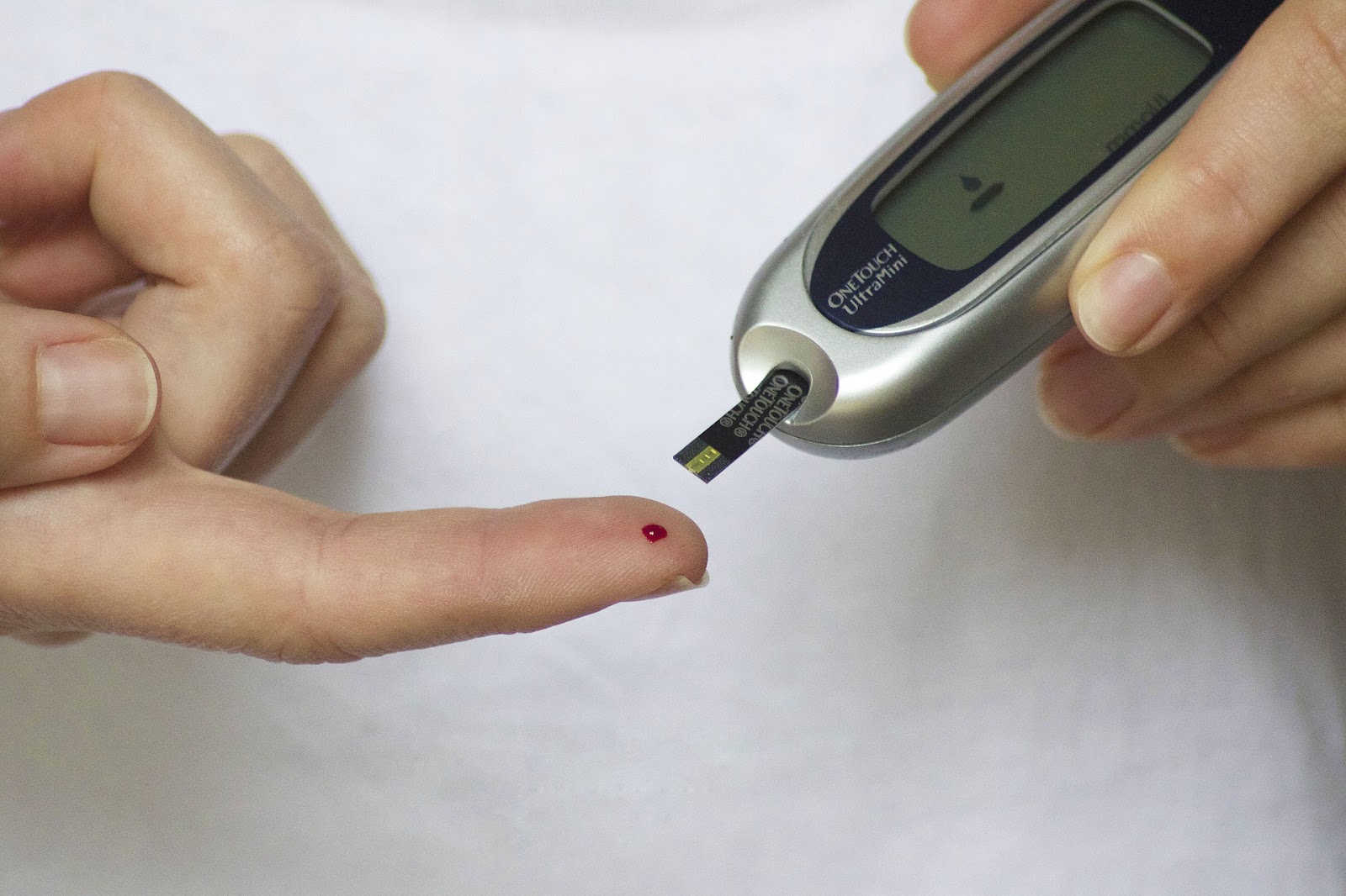 A person testing the blood sugar levels