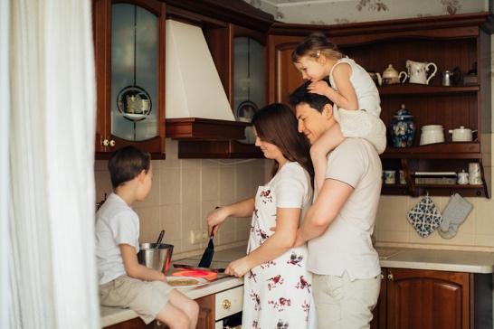 Happy family together in the kitchen.