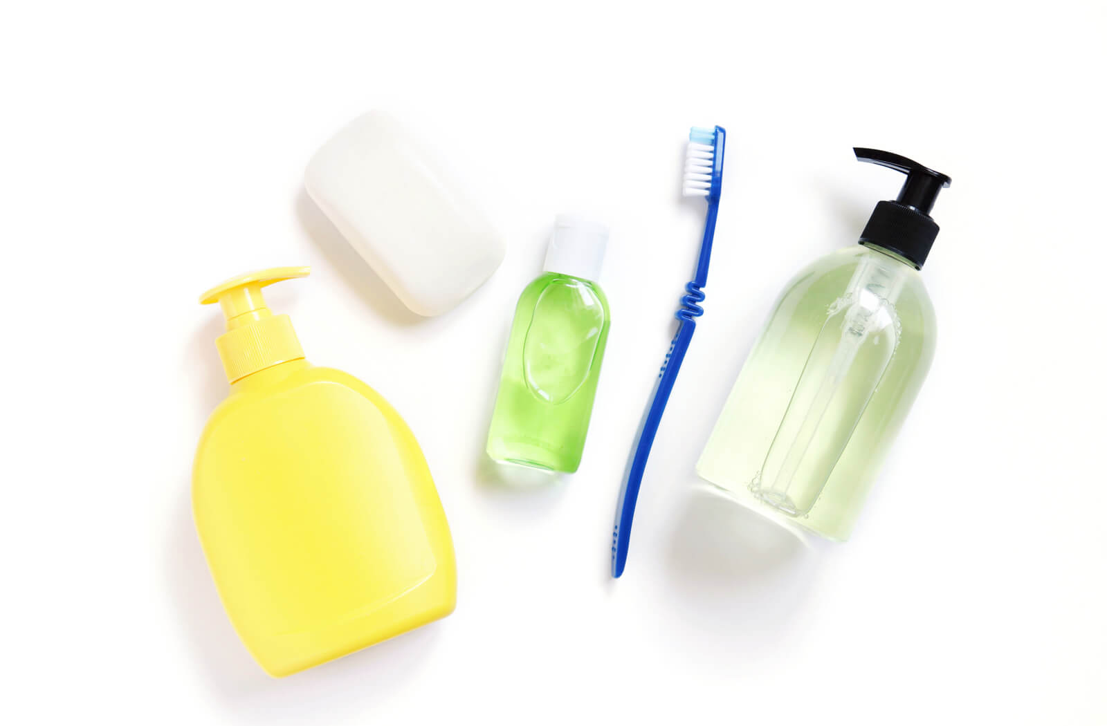 an assortment of personal care items hand sanitizer toothbrush soap and shampoo