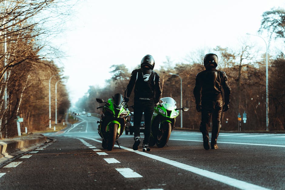 Two People Standing on the Road with Their Motorcycles