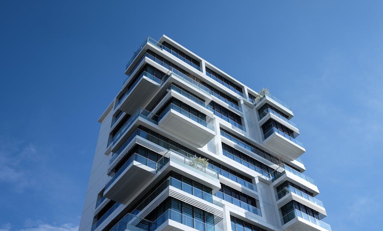 Free White Concrete Building Under Sunny Blue Sky Stock Photo