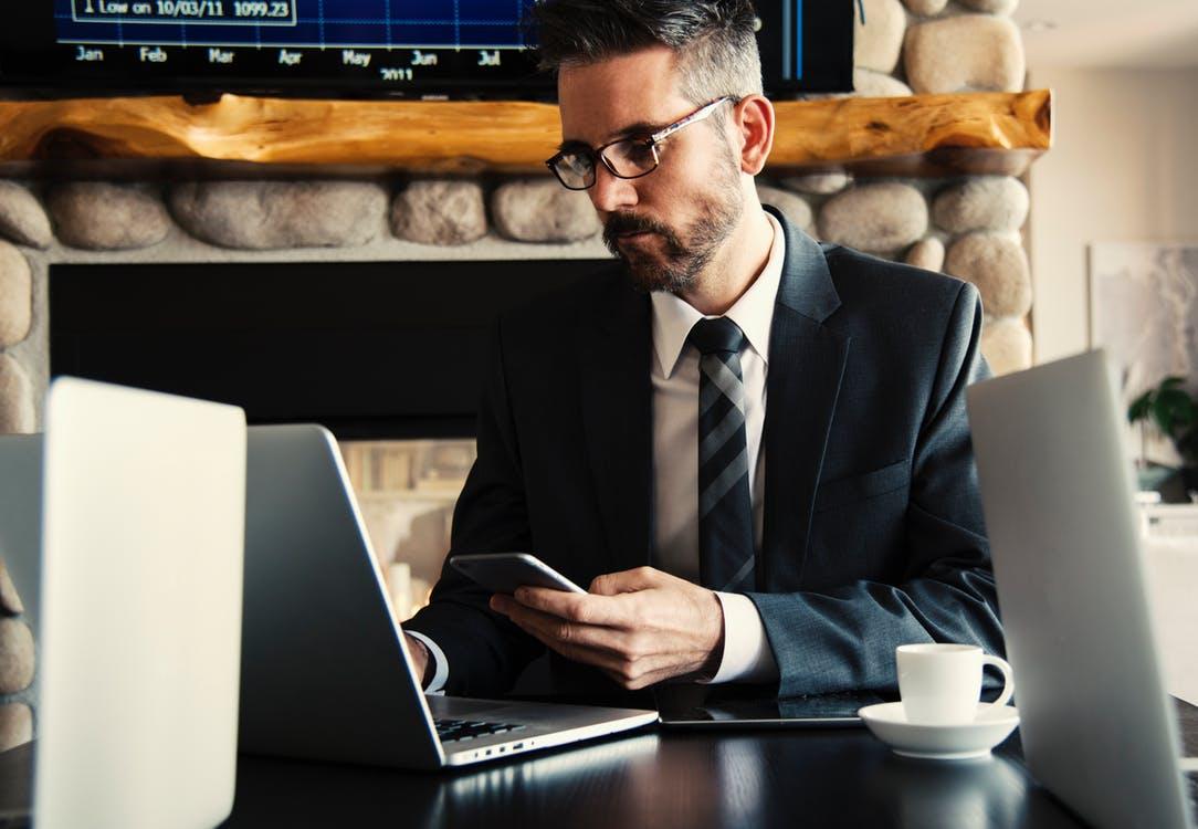 A man in a suit using a laptop at work