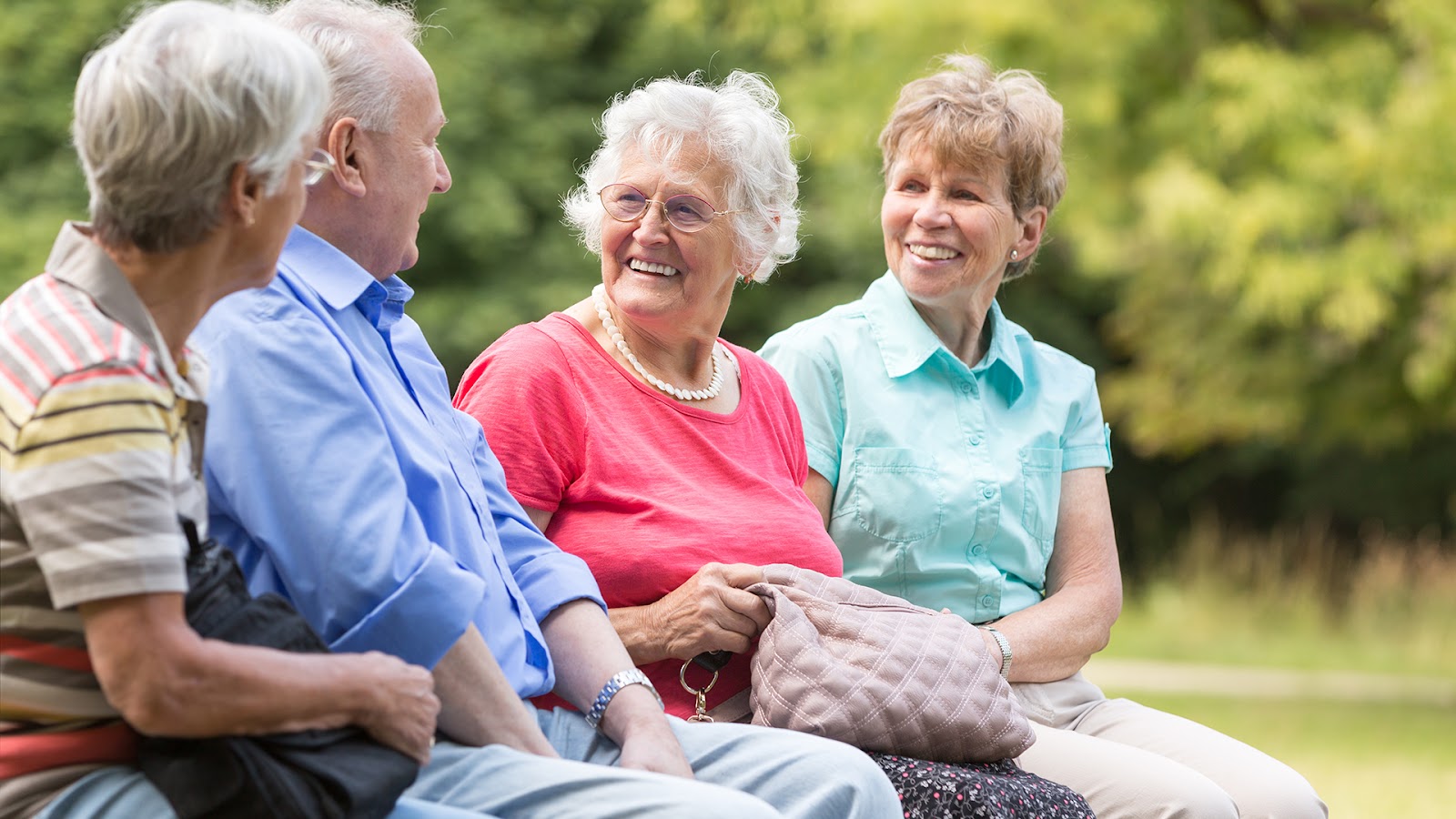 seniors sitting outside together smiling