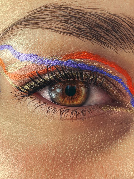 neon, graphic eyeliner in orange, gold, and blue