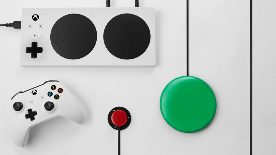 Xbox adaptive controller with a green switch, a red switch and a standard XBox controller.