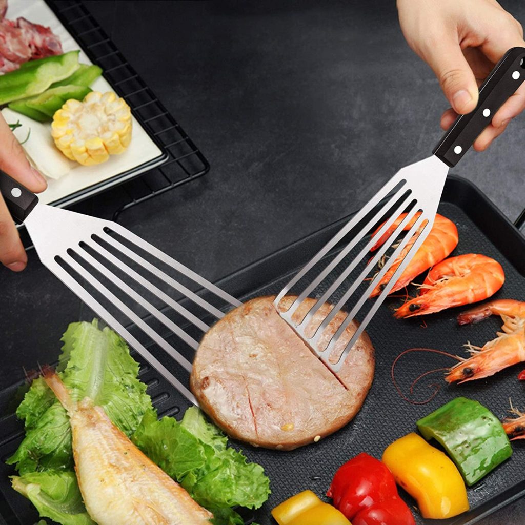 Fish spatula being used to plate fish