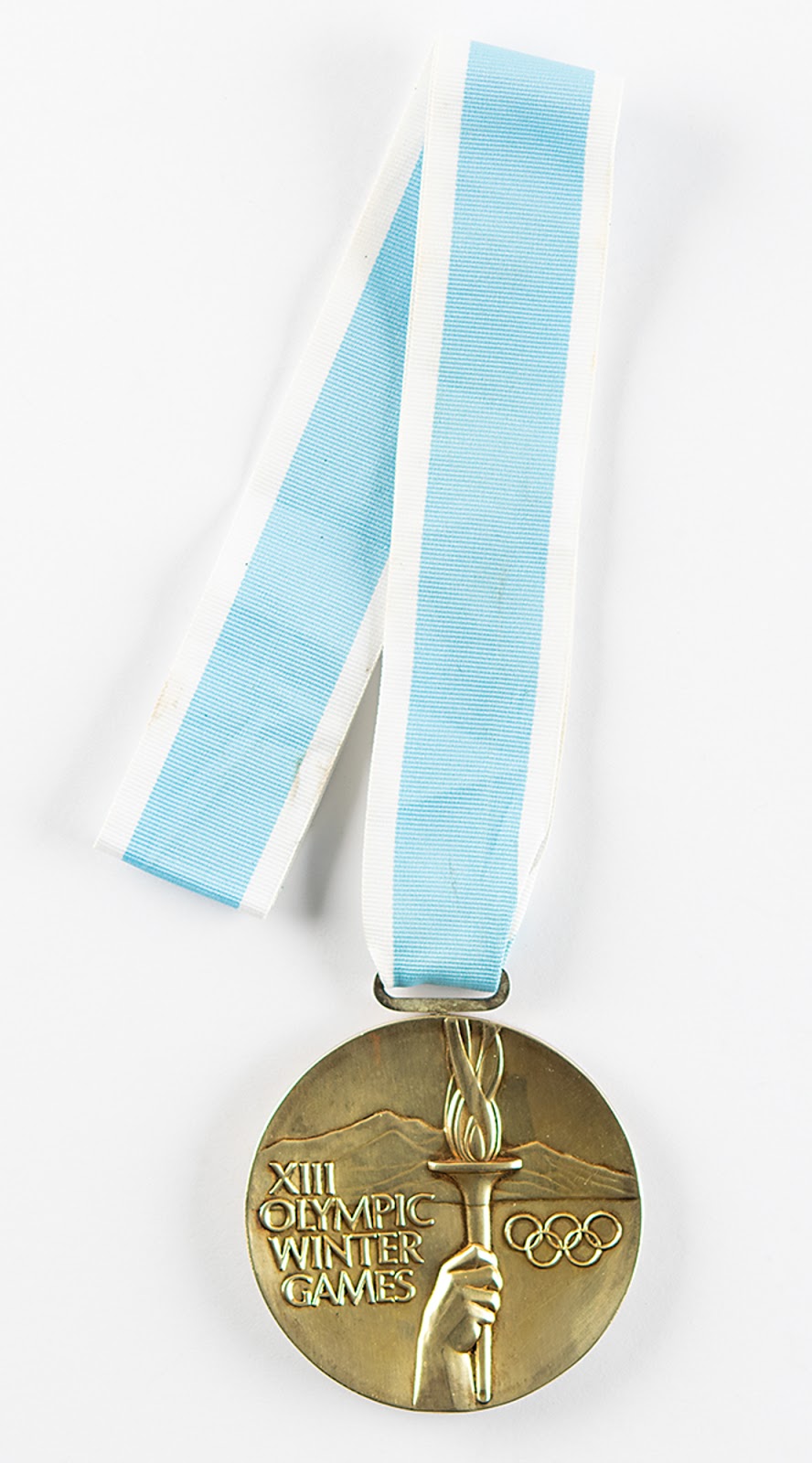 The Lake Placid 1980 gold winner’s medal awarded to Russian skater Alexander Zaitsev. This medal was manufactured by luxury jewelry company Tiffany & Co. and retains its original light blue and white ribbon. RR Auction sold this lot for $93,748.