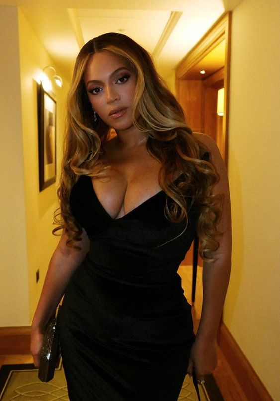 Beyonce in a black dress rocking her signature  blonde hair