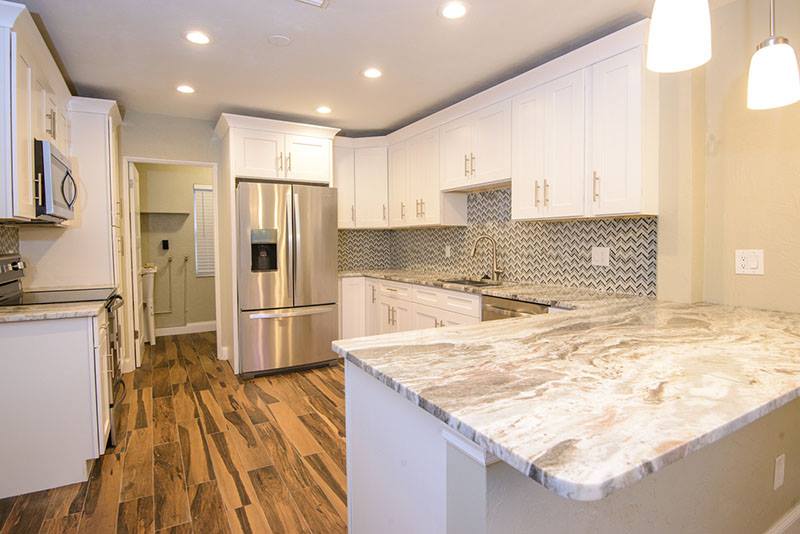 traditional white kitchen with shaker cabinets and wood floors