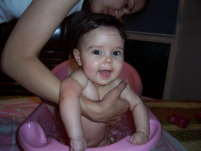 A newborn getting a bath.