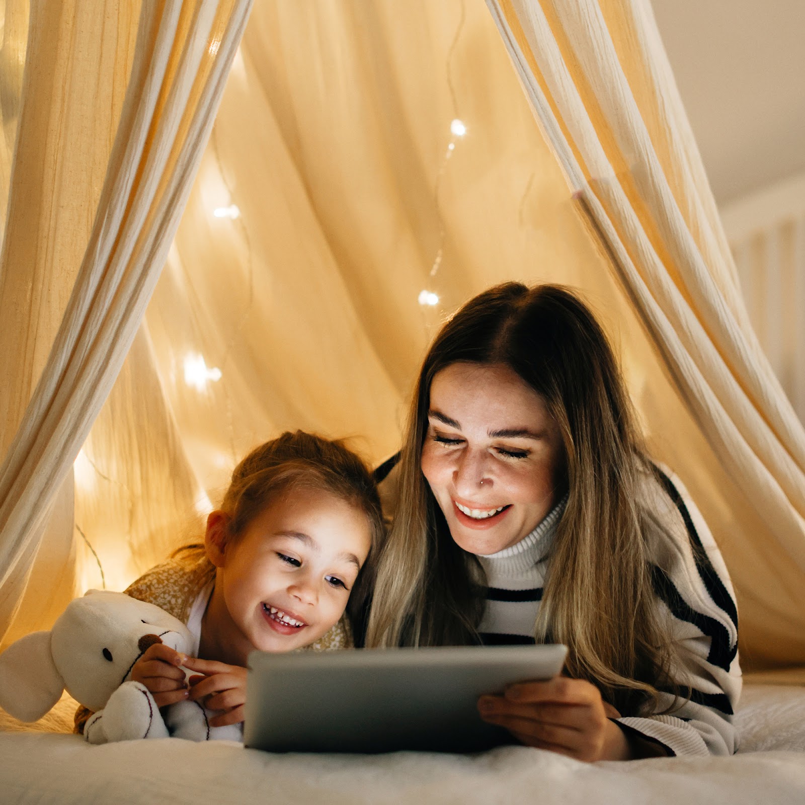 mother and child in cozy lighted reading nook