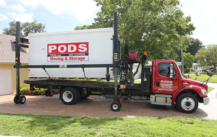 PODS Moving & Storage truck delivering a PODS container.