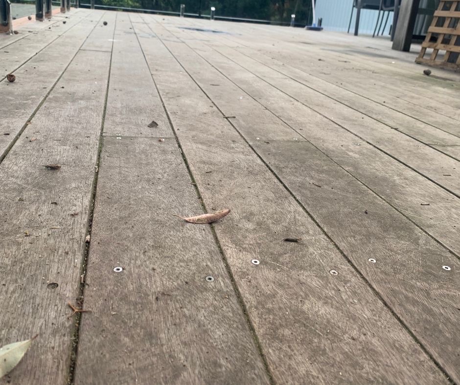 Use a deck cleaner and brush to clean a deck like this 