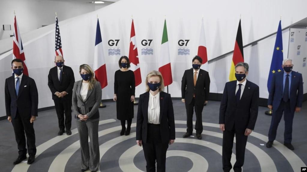 7 foreign ministers, pose in a socially distanced manner for a group photo at the Museum of Liverpool, Liverpool, England, Saturday Dec. 11, 2021. Foreign Secretary Liz Truss is hosting U.S. Secretary of State Antony Blinken and other Group of Seven count