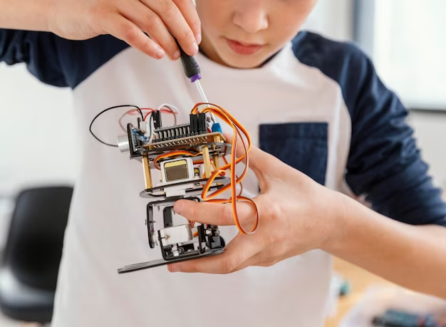 Child makes robots, close up