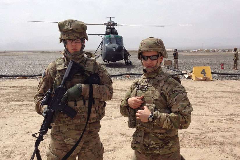 Father Lukasz J. Willenberg poses with an unidentified U.S. Army chaplain assistant in 2015 at Bagram Air Base in Afghanistan, where he was deployed as an Army chaplain.