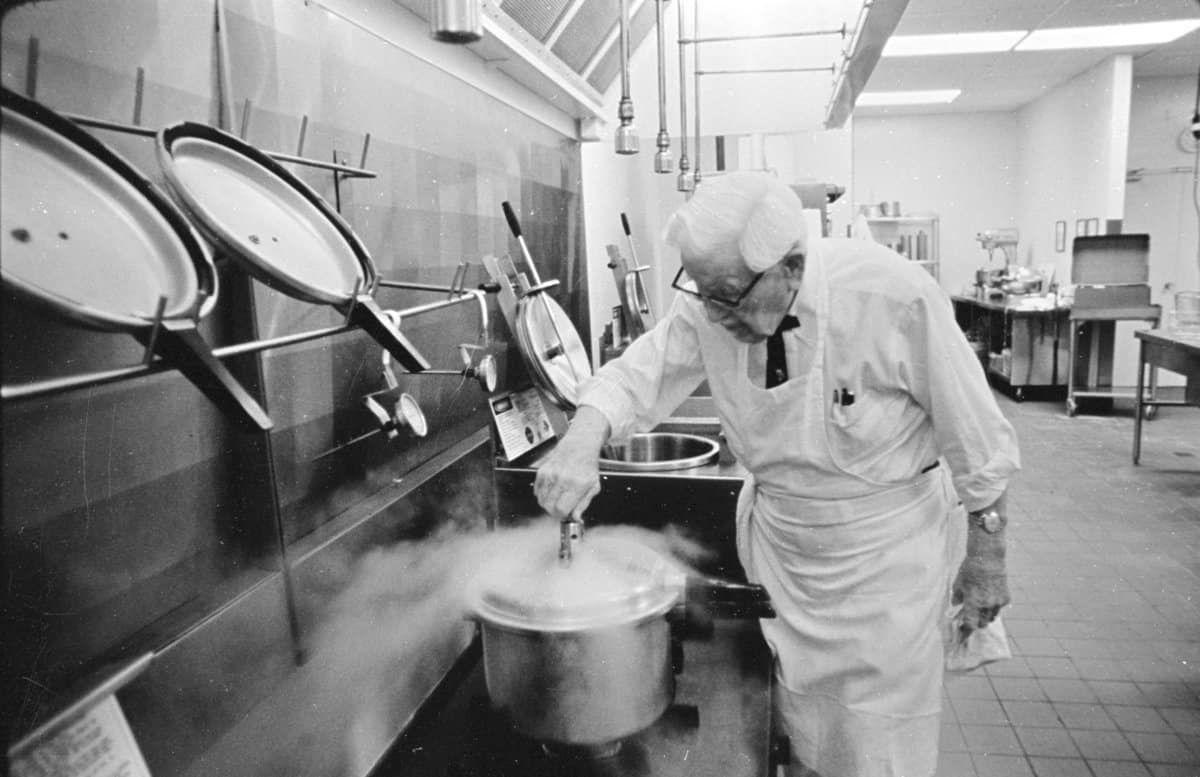 Colonel Sanders cooking in a restaurant kitchen