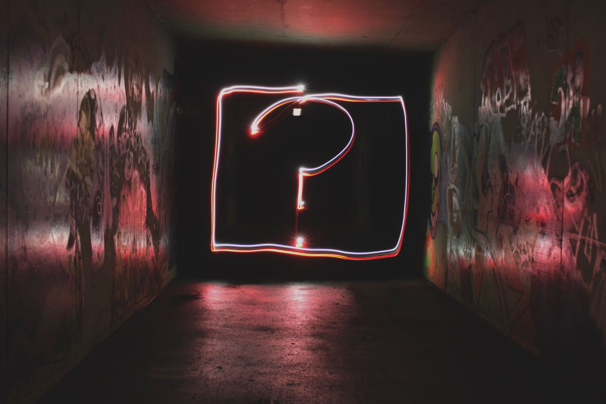 An image of a neon question mark, the representation of the phrase, "What's my point?"