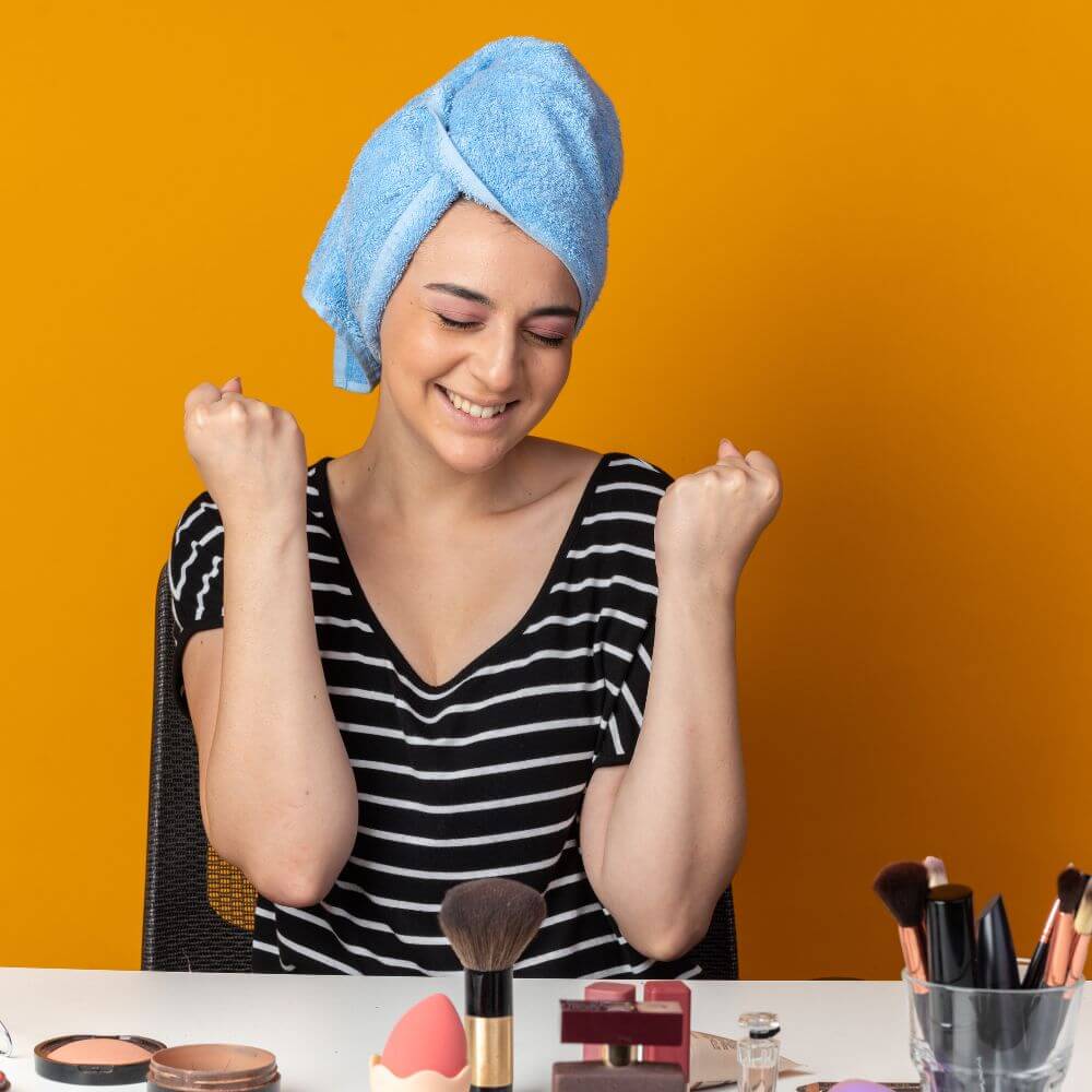 woman at makeup table with concealer