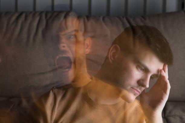 Angry And Stressed Man At Home Multi Exposure Of Young Angry And Stressed Man At Home PTSD and anxiety stock pictures, royalty-free photos & images
