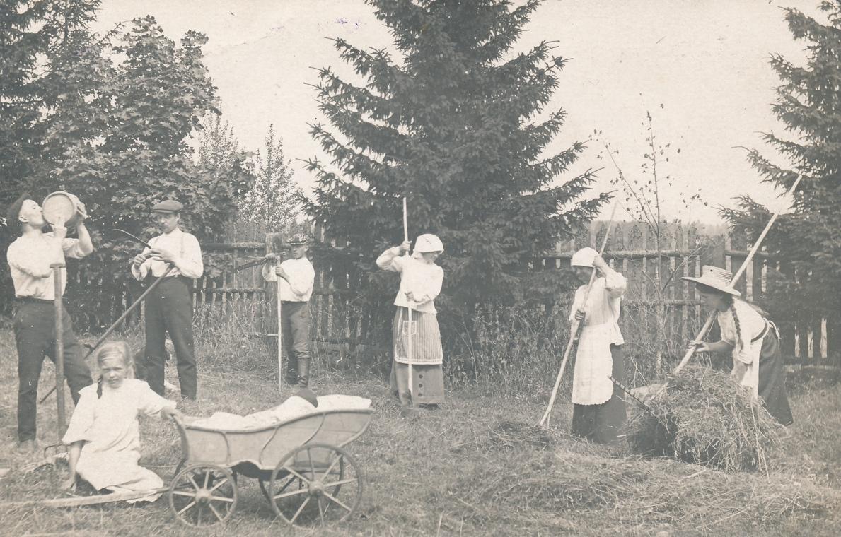 A vintage photo of a group of people posing for the cameraDescription automatically generated