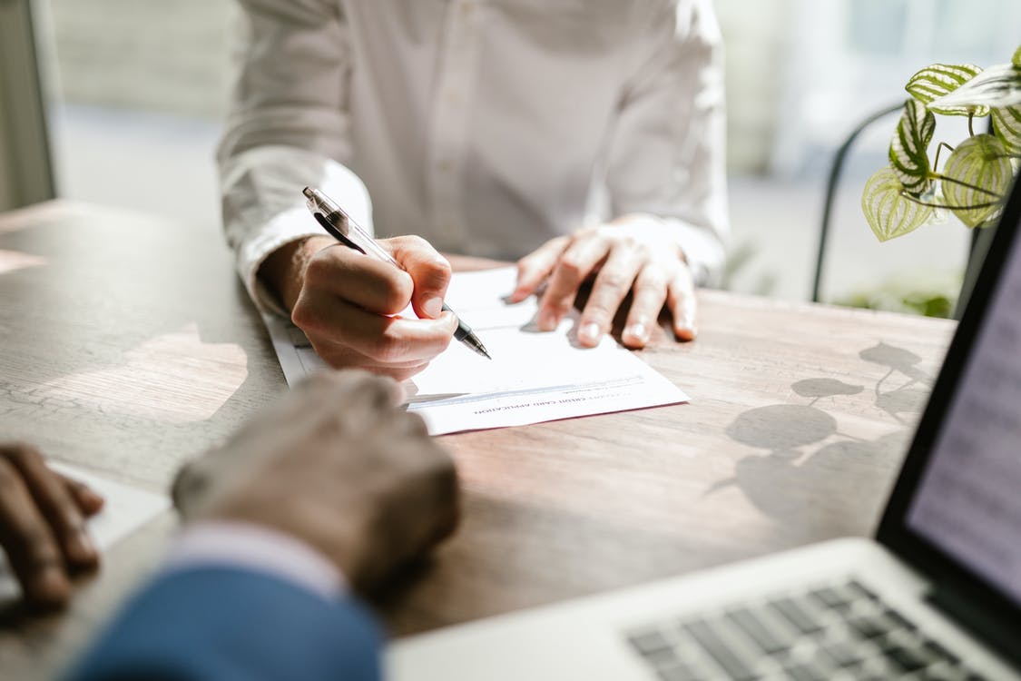 Person signing insurance document 