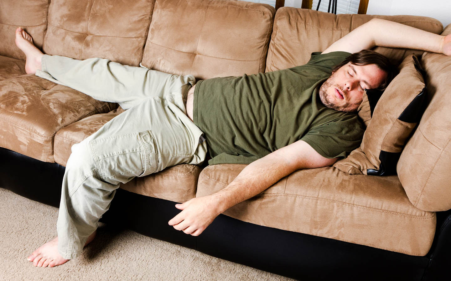 lazy guy sleeping on couch among the Types of Landlords to avoid